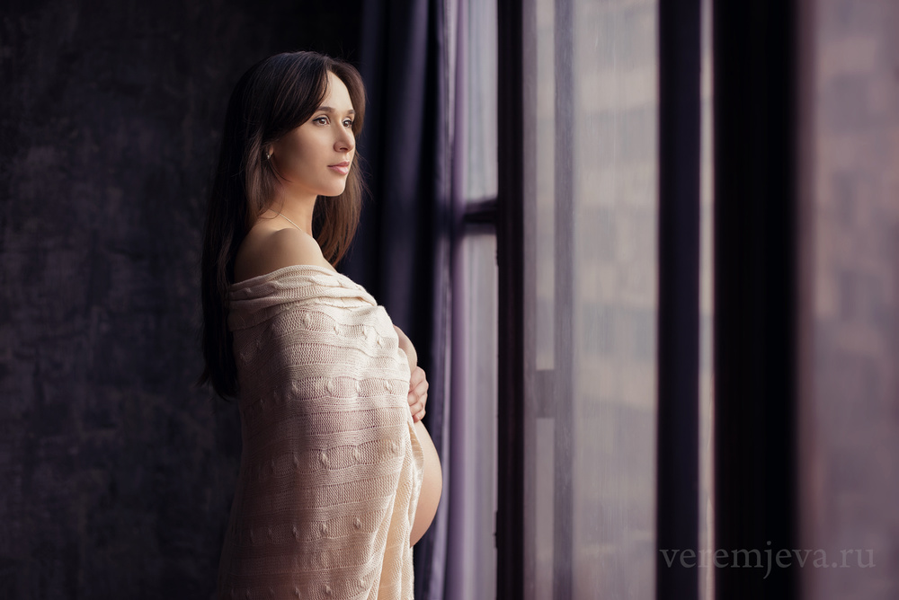 беременная в темной студии